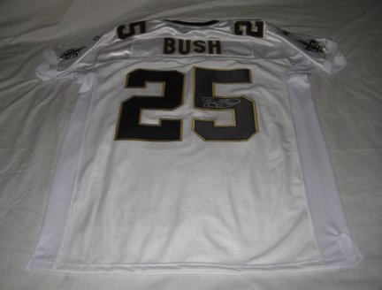 Reggie Bush Autographed New Orleans Saints Super Bowl XLIV Jersey W/PROOF, Picture of Reggie Signing For Us, New Orleans Saints, Super Bowl Champions, Miami Dolphins, USC Trojans, Heisman Trophy Award, National Champion