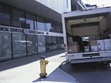 Back of Delivery Van Full of Packages on Street by Downtown Financial Services Building Photographic Poster Print, 32x24