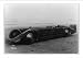 Historic Print (S): [Driver seated in long racing car on beach]
