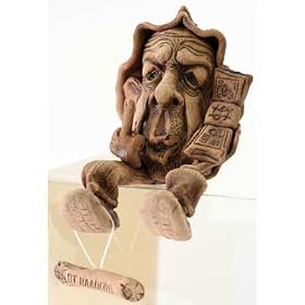 CERAMIC AMULET/Anti-Taxes Gnome [Made in Russia. Height: 4.5 inches (12 cm). Material: ceramic (clay). Hand-crafted] [A gnome holding a stack of money in one hand and making a defiant gesture with the other. This marvelous sculpture is shaped to "sit" on the edge of a shelf or chest. An engraved tablet hangs from his foot. Use this good-luck creature to add a touch of whimsy to any room in your house. Amulets, or talismans, possess a magical ability to defend their owners or improve various areas of their lives. They can protect against sickness, bad luck, and danger; they can also bring success, luck, love, money, and more. This gnome - hand-sculpted from natural clay - will tirelessly defend you and your loved ones from any sort of misfortune!]