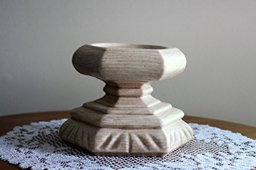 A solid bone colored, hexagon shaped ceramic candleholder.