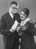 Couple Reading Insurance Brochure Photographic Poster Print by George Marks, 30x40