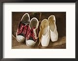 A Pair of Tennis Shoes with Red Laces Sits Next to a Pair of Ballet Slippers Framed Photographic Poster Print by Jodi Cobb, 21x17