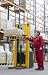 Wallmonkeys Peel and Stick Wall Decals - Senior Worker in Red Uniform with Bar Code Reader in Warehouse - Removable Graphic