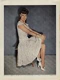 GINGER ROGERS: For old times sake Ginger wears a dress her mother made for her when she appeared at a St. Louis Vaudeville Theater 14 years ago. The dress still fits. ..... 1942 LIFE Magazine Picture, A3607A.
