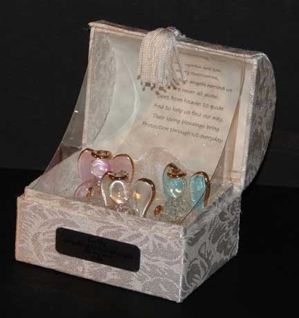 PERSONALISED GUARDIAN ANGEL BLESSING BOX This beautiful box contains three glass guardian angels gilted in 22KT gold, The box is embossed ivory fabric and will be personalised with your own special message up to 50 characters, making this a perfect gift for any occasion. There is a Guardian Angel Blessing verse inside the lid, When our spirits are low, And worry overcomes Three guardian angels remind us We are never alone Sent from Heaven to guide And help us find our way, Their loving blessings bring Protection throughout everyday
