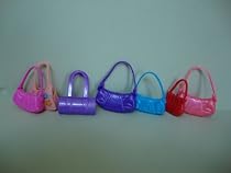 A Set of 7 Barbie Purses Various Colors and Styles.