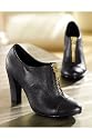 Newport News Shoe boot with bold, golden front zipper