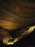 Man Stands in a Cave Chamber in Rumbling Falls Cave System National Geographic Collection Photographic Poster Print by Stephen Alvarez, 24x32