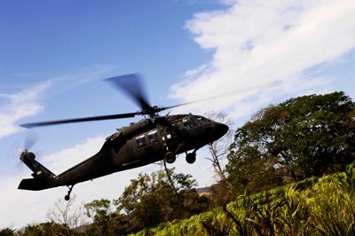 Wallmonkeys Peel and Stick Wall Decals - A U.s. Army Uh-60 Black Hawk Helicopter Flies out of an Emergency Landing Zone. - 24"W x 16"H Removable Graphic