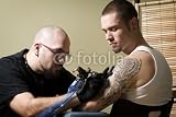 Wallmonkeys Peel and Stick Wall Decals - Tattooer Concentrating on Giving Someone a Tattoo - Removable Graphic