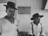 Migrant Workers Sitting in Front of a Sign Posted for Rochester People to Keep Out Photographic Poster Print, 16x12