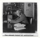 Historic Print (L): [Government official seated at his desk wearing head phones and tuning small radio]