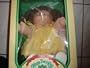 Cabbage Patch Kids 1985 Doll with blond hair, yellow sweater and one tooth sticking out