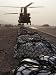 Marine Specialists Attach Sling Loads to the Body of an Army CH-47 Chinook Cargo Heli...