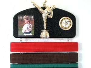 Martial arts belt display with a KICK ! Midn. trophy male. Expandable to hold ALL your belts !