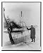 Historic Print (L): [Scientist, possibly Dr. Robert H. Goddard, posed with a rocket]