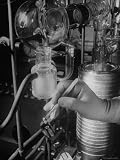 Crucible Being Loaded with Forceps Into a Small Electric Furnace Photographic Poster Print by Fritz Goro, 12x16