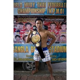 photographie Young man holding boxing belt in front of truck advertising Muay Thai (Thai boxing) ...