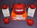 Cerise Le Creuset 22cm round casserole & four petite casseroles