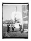 Historic Print (L): Kellogg raising flag at opening game, 4/22/25
