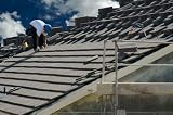 Roofer Laying Tile Shingles on a New Home - 24