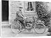 Canvas Prints of Man on an early motorcycle in front of a house from Mary Evans