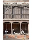 Photographic Print of Three old men watch the world go by on a street in Bhaktapur from Robert Harding