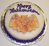 Carrot Decorated Cake Single Layer 8 Round Topped with Bat Cookie Purple Trim