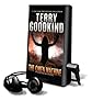 The Omen Machine [With Earbuds] (Playaway Adult Fiction)