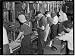 Photo Production. Willow Run bomber plant. Drill press lineup, 1943 style. Both men and women man th