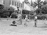 Father Cutting Lawn With Power Mower, Two Boys Using Toy Rake and Mower Photographic Poster Print by H. Armstrong Roberts, 12x16