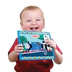 Child smiling holding Tomy Aqua Draw Mini Mats - Thomas & Friends