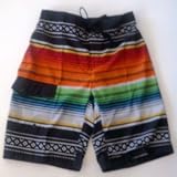 Mens Swim Trunks/Board Shorts. Black/Multi or White Multi. Elastic waist, board short front, velcro fly and side flap pocket. Fully lined. Sizes S-XL.