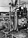 Italian Physicist Enrico Fermi Peering Out from Behind Large, Complicated Machinery i...
