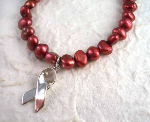 Click here to buy Sterling Silver Ribbon Red Pearl Breast Cancer Awareness Charm Bracelet.