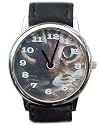 Tabby Cat watch smaller of one inch dial.Gold tone case with black leather band. Battery operated.