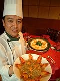 IMAGE OF A Chef at the St. Regis Hotel Displays Plates of Chinese Cuisine Premium Photographic Poster Print, 24x32