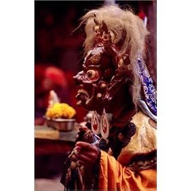photographie A monk in an elaborate mask and costume performing ritualistic dance at the Mani Rim...