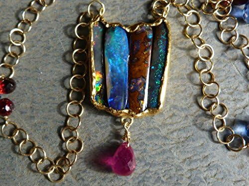 18 kt yellow gold necklace with 4 australian boulderopals,a ruby briolette, garnets and cyanites