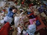 Children Laugh as They Lay in Wrapping Paper from Christmas Presents Photographic Poster Print by Joel Sartore, 42x56