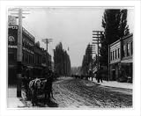 Historic Print (L): [Street scene in Lewiston, Idaho, including stores and horse-drawn wagons]