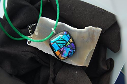 Bitter is a Hand Engraved Dichroic Glass, Picasso Style Fused Glass Pendant. There is a Window in the Lower Left Corner that is a Symbol for a Window into the Soul.