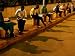 Young Guineans Study under the Dim Parking Lot Lig