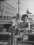 Shoe Repair Clerk Taking Information from Drive in Customer as Another Customer Waits Inside Store Photographic Poster Print by Nina Leen, 24x32