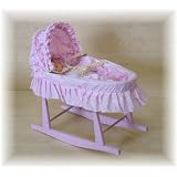 Dolls pink toy moses basket and pink rocking stand'