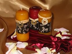 A Set of Three Scented Candles in a Satin Gift Bag