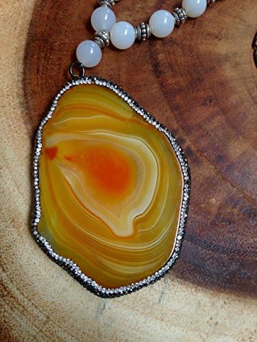 Gorgeous Large Orange Oval Marble Slice surrounded by hematite and clear crystal pave CZ.