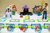 Adorable Disney Little Mermaid 15 Piece Birthday Cake Topper Featuring Ariel, Prince Eric, Max The Sheep Dog, Ursula, King Triton, Sebastian, Flounder, 6 Little Mermaid Themed Buttons, Decorative Sand Castle and Decorative Ship Wheel