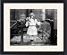 Framed Prints of SPIRIT PHOTOGRAPH, c1905. A young girl holding flowers, surrounded by spectral from Granger Art on Demand